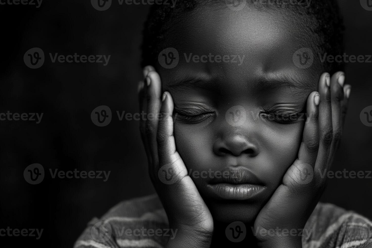 Sad child covering ears, expressing distress in a dimly lit room during a quiet moment photo