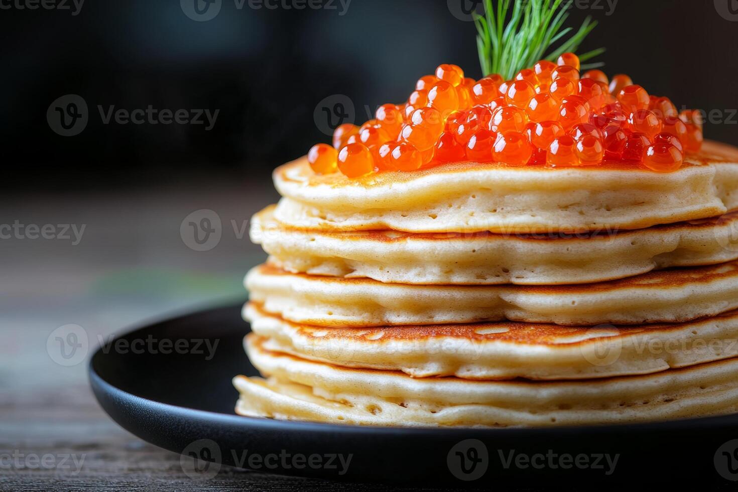 Stack of fluffy pancakes topped with vibrant salmon roe for a gourmet breakfast experience photo