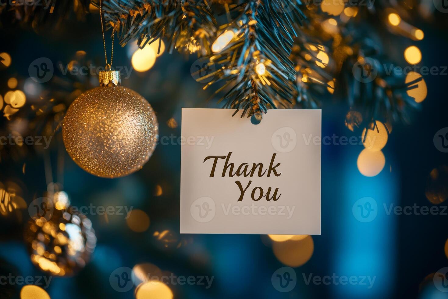 A heartfelt thank you on a card hanging from a decorated Christmas tree with shimmering golden bokeh in a cozy blue atmosphere photo