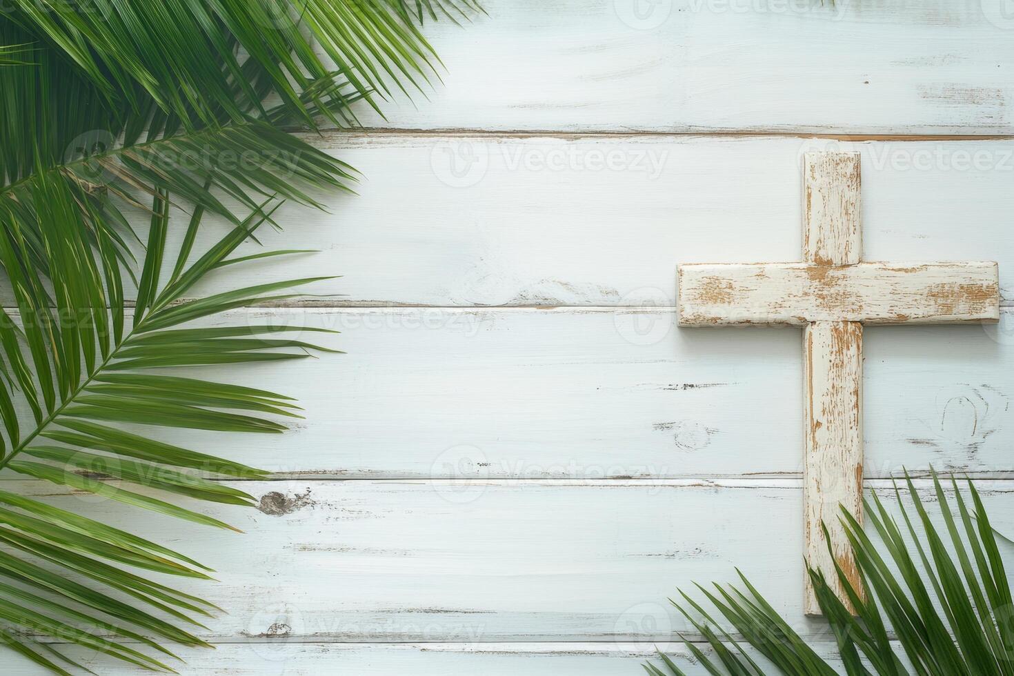 Wooden cross with palm leaves on a white wooden background symbolizing faith during Holy Week and religious observances photo
