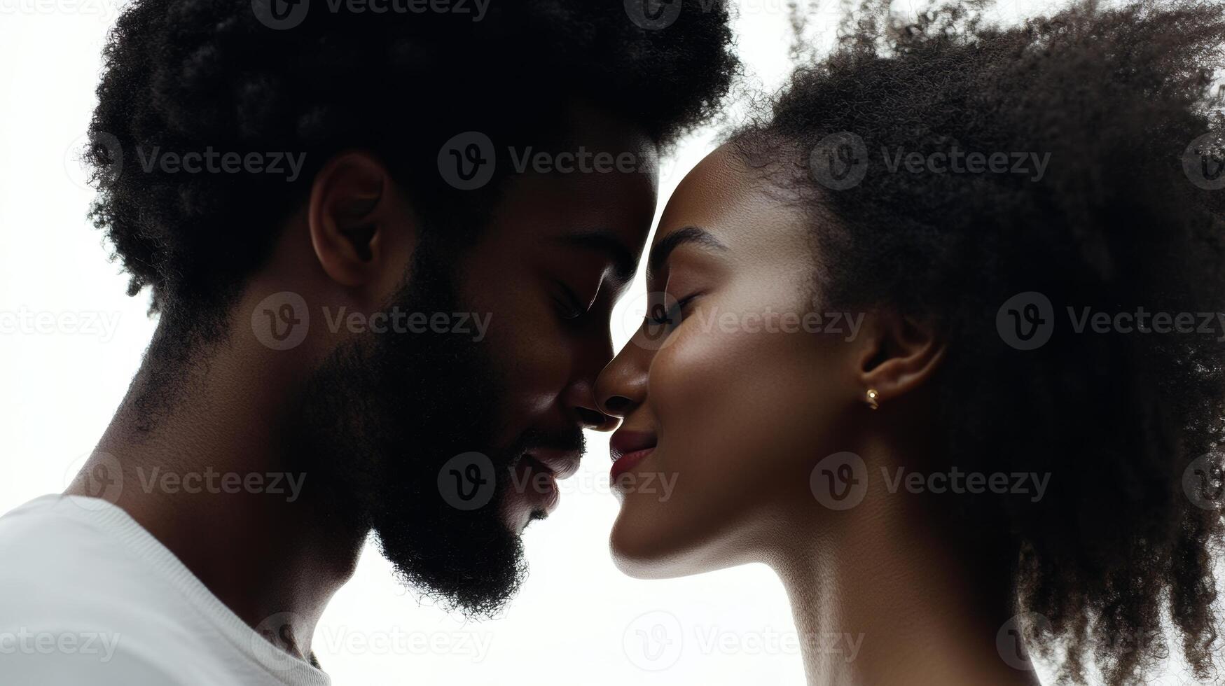 A romantic black couple shares a loving kiss while gazing into each other's eyes against a clean white background photo