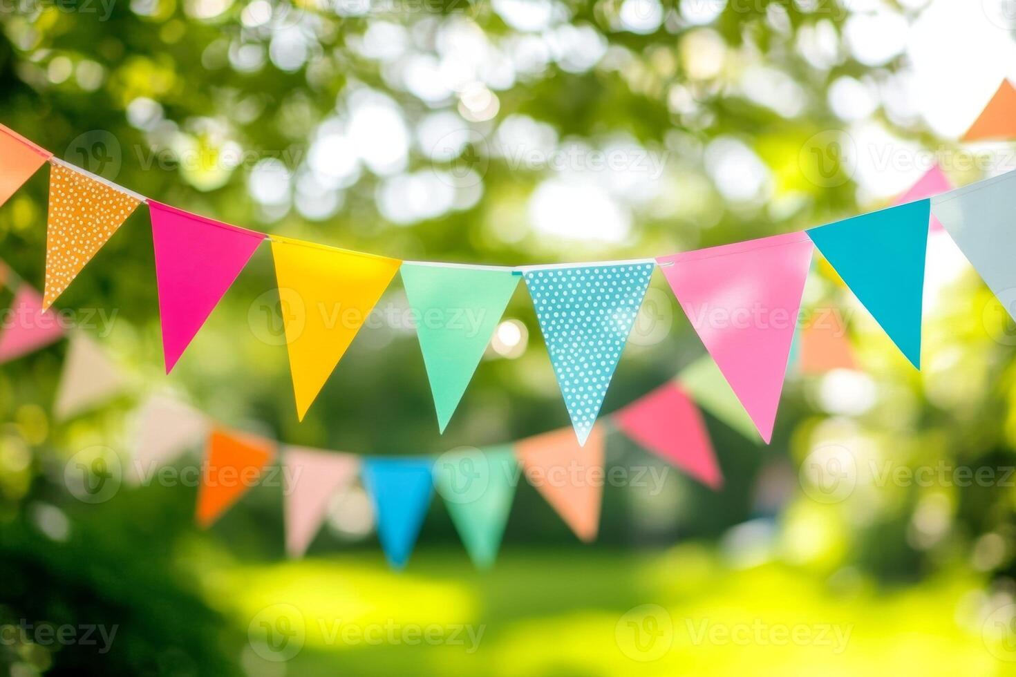 Colorful bunting flags strung across trees at a joyful outdoor celebration on a sunny day photo