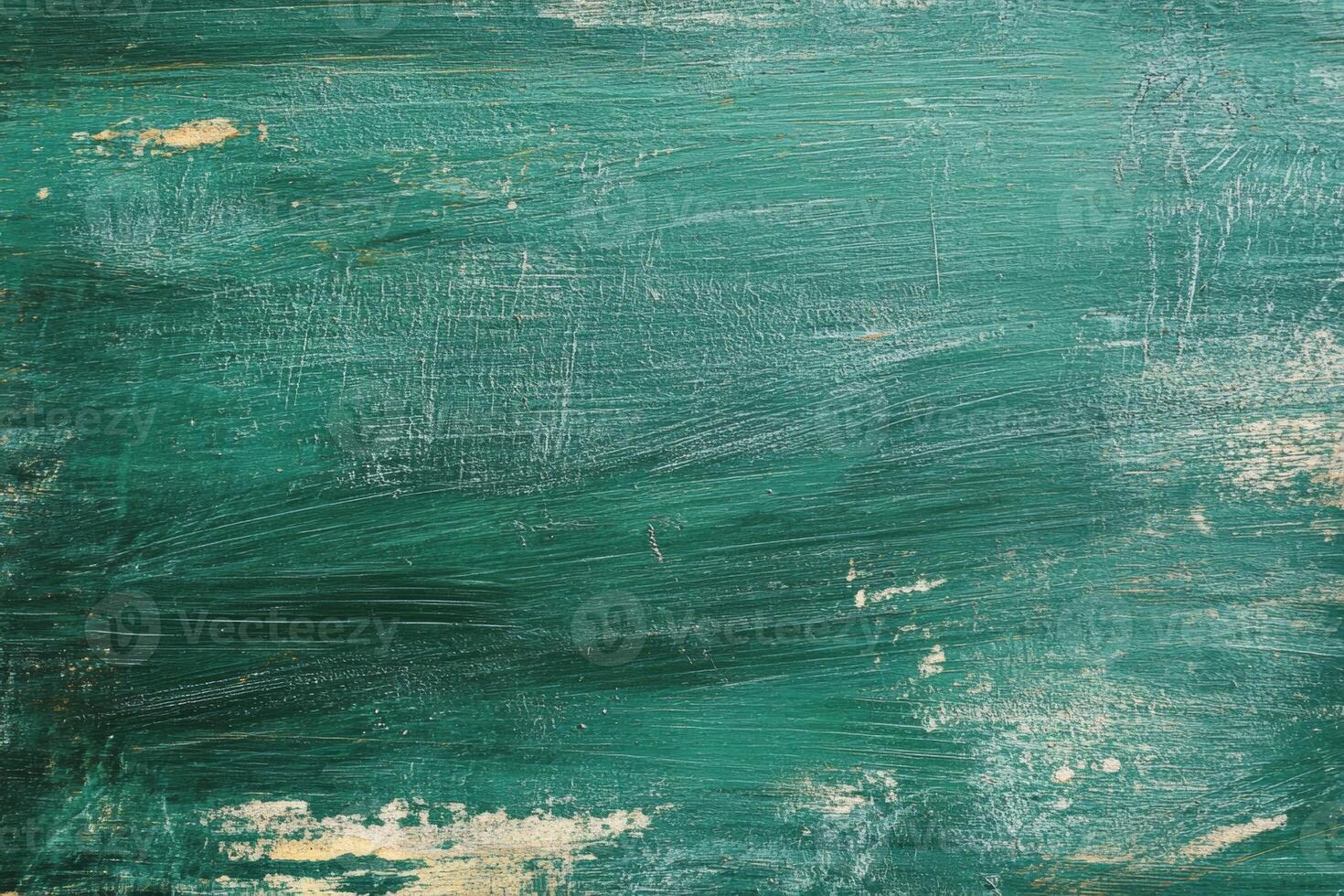 The texture of a worn green chalkboard with traces of chalk dust and a rustic, erased appearance suggesting long-term use in a classroom setting photo