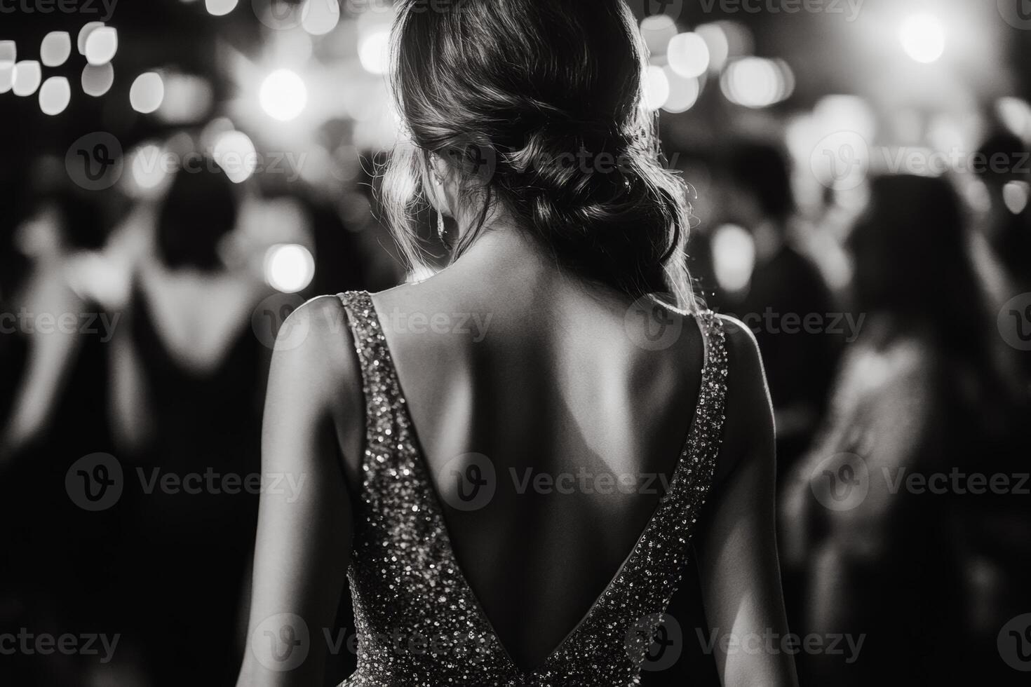 An elegant woman in a sequined dress enjoys a vibrant night on a crowded dance floor filled with lively partygoers photo