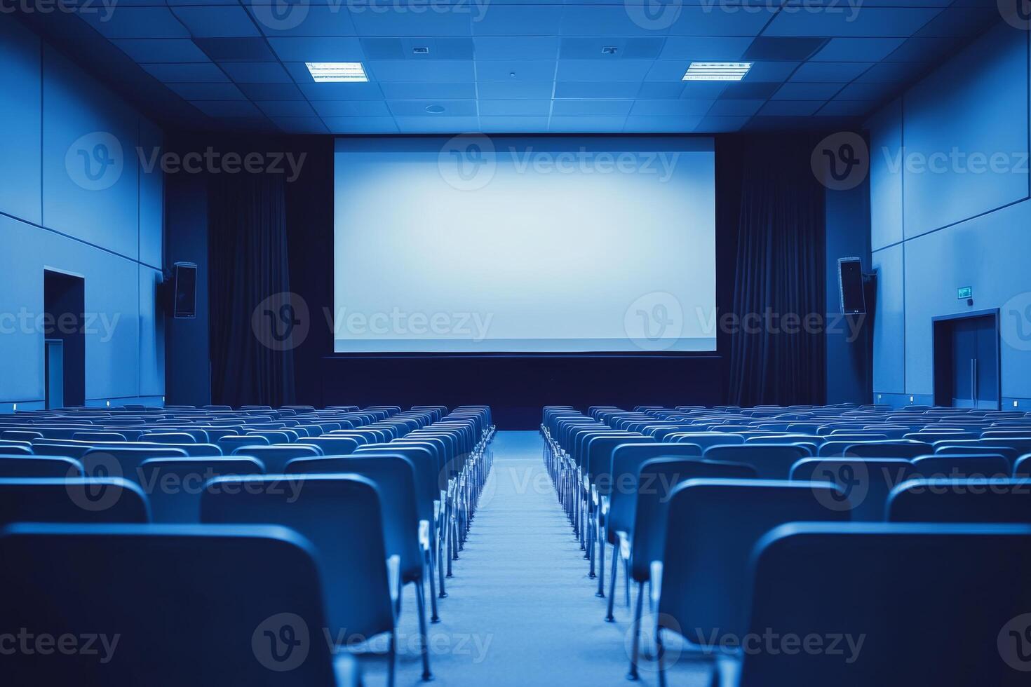 Modern minimalist conference room featuring rows of chairs and a projector screen set for a professional presentation during the day photo