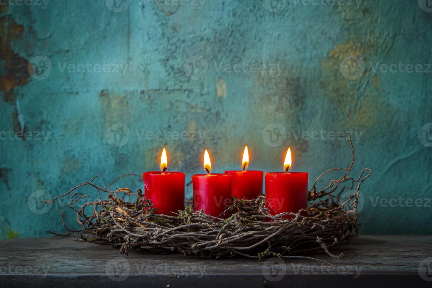 Advent wreath with four burning red candles set against a rustic background in France during the Christmas season photo