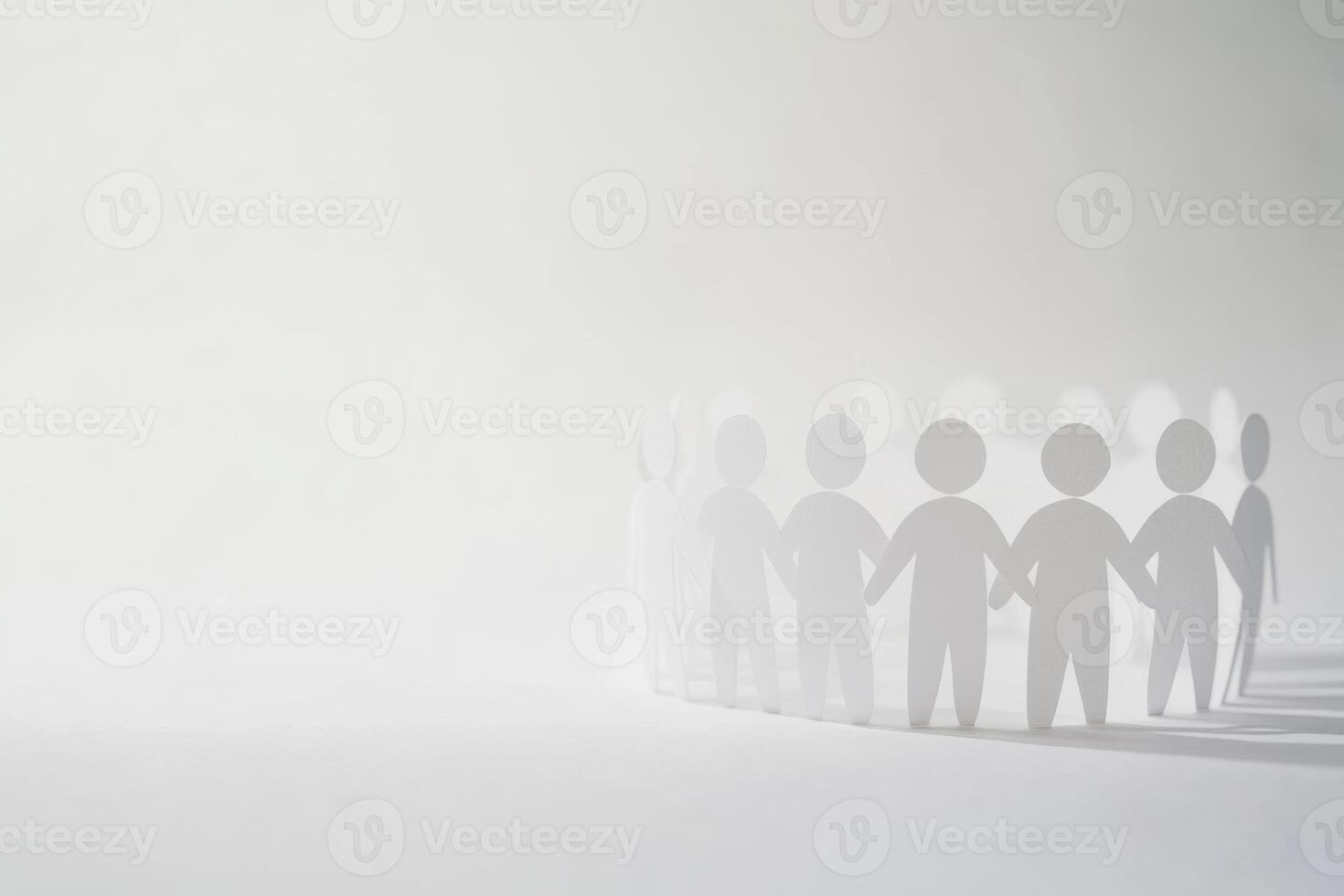 Silhouettes of people holding hands in a misty environment conveying unity and togetherness photo