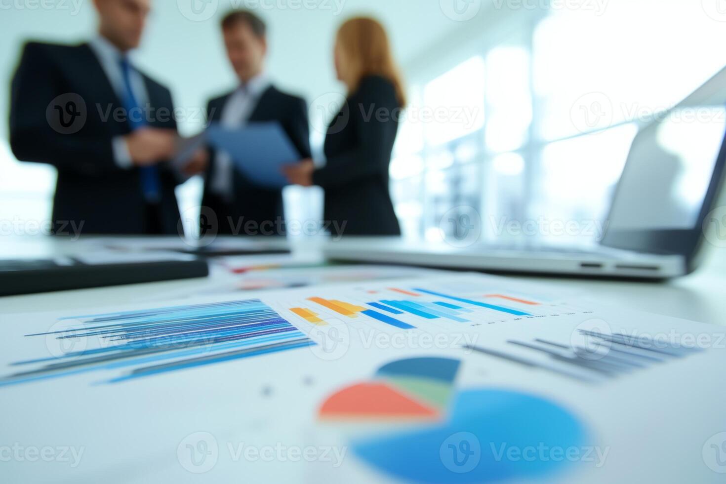 Business professionals discussing reports and data analysis in a modern office during working hours photo