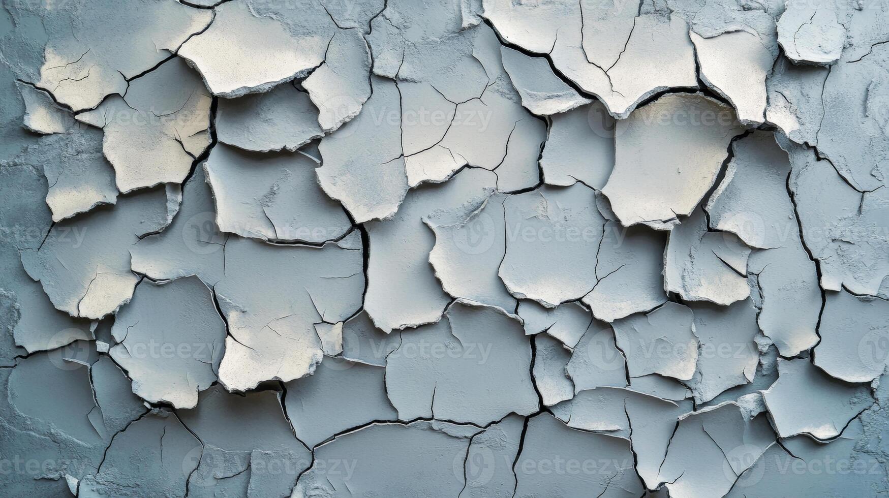 Cracked gray wall texture with peeling paint showcasing intricate patterns in a weathered design photo