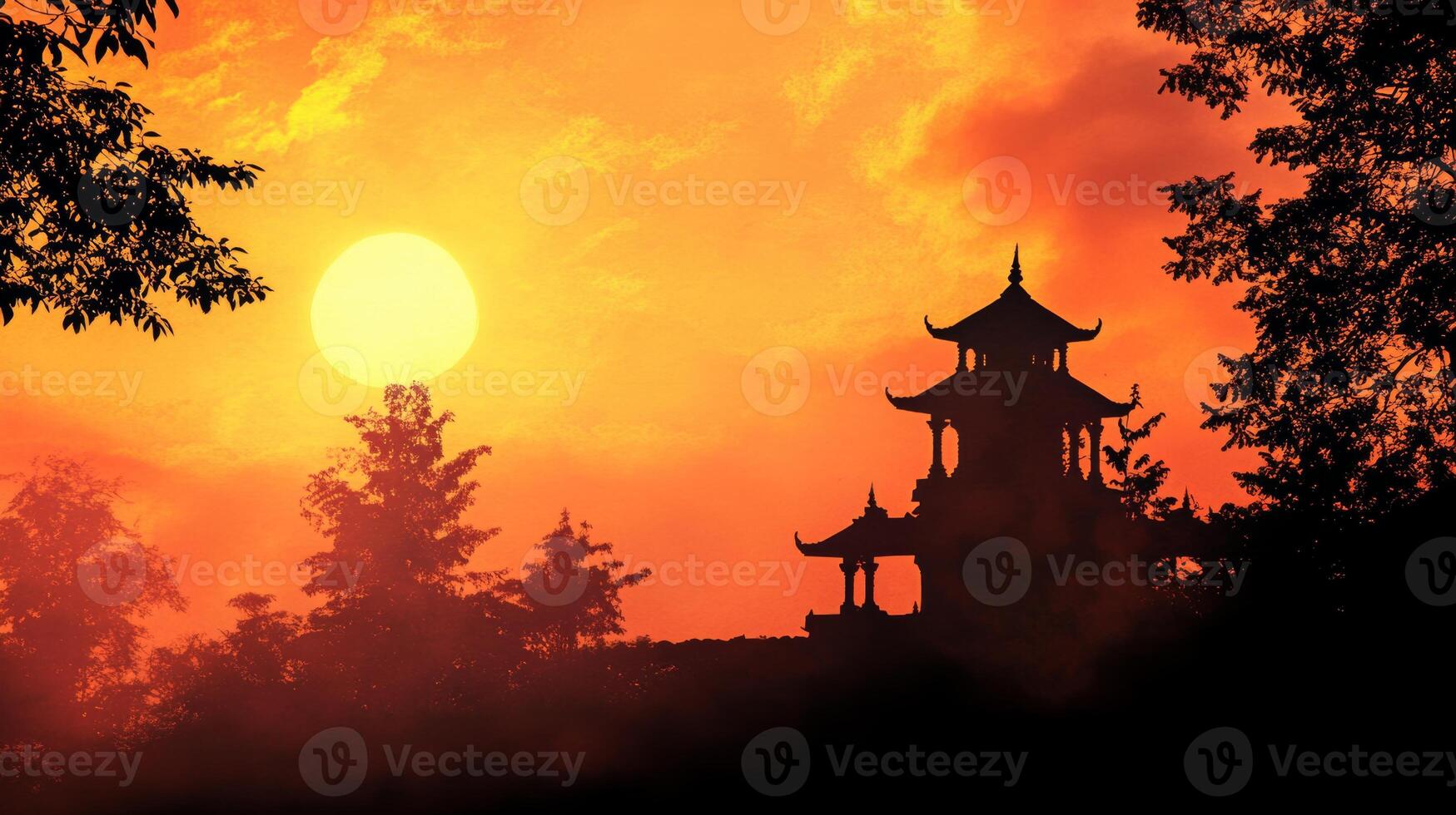 Silhouette of an Indian temple against a vibrant sunset sky with dramatic colors and empty space for text above photo