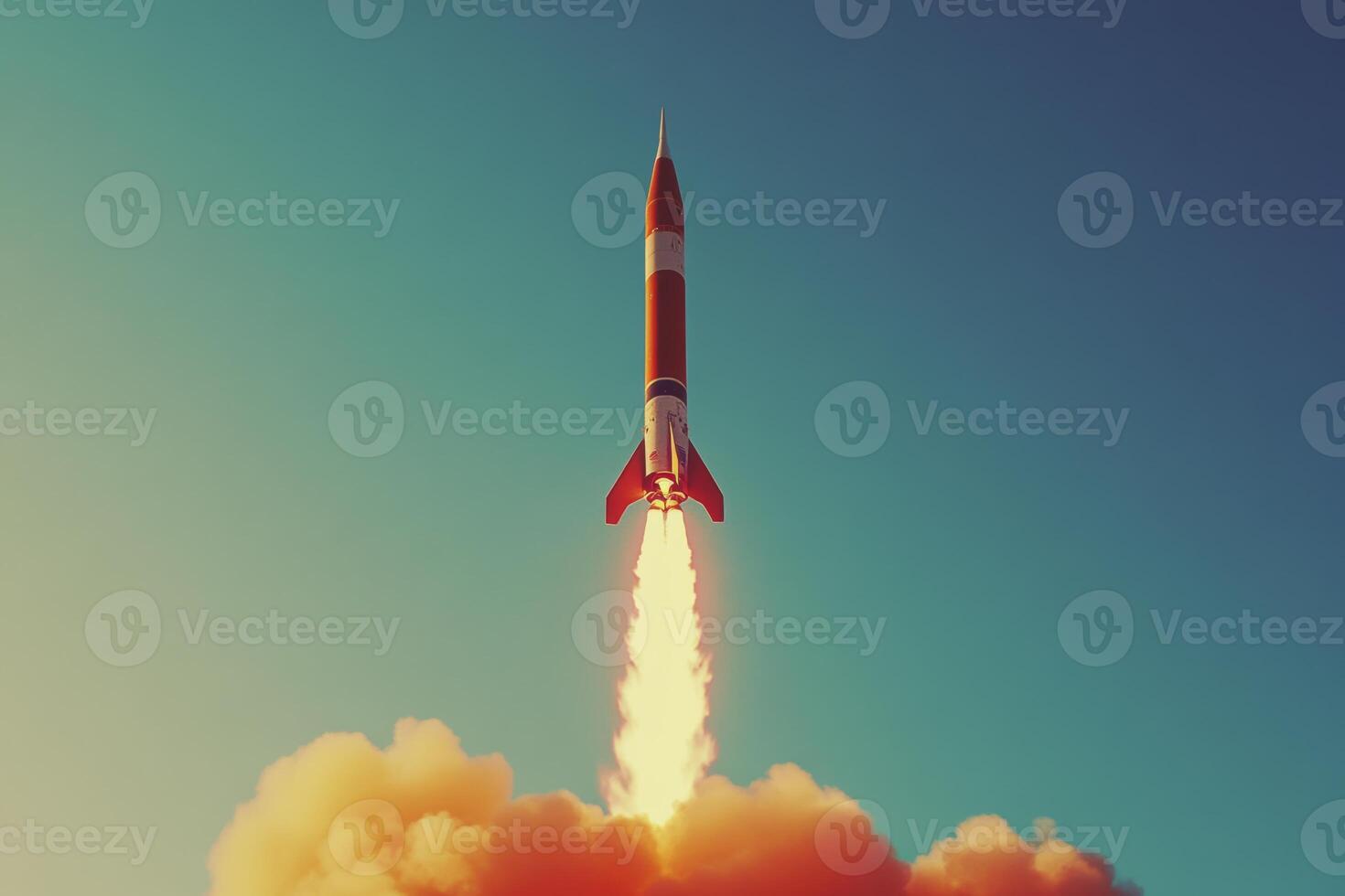 A rocket launches into a clear blue sky, leaving a trail of vibrant flames and smoke behind in a spectacular display of innovation photo