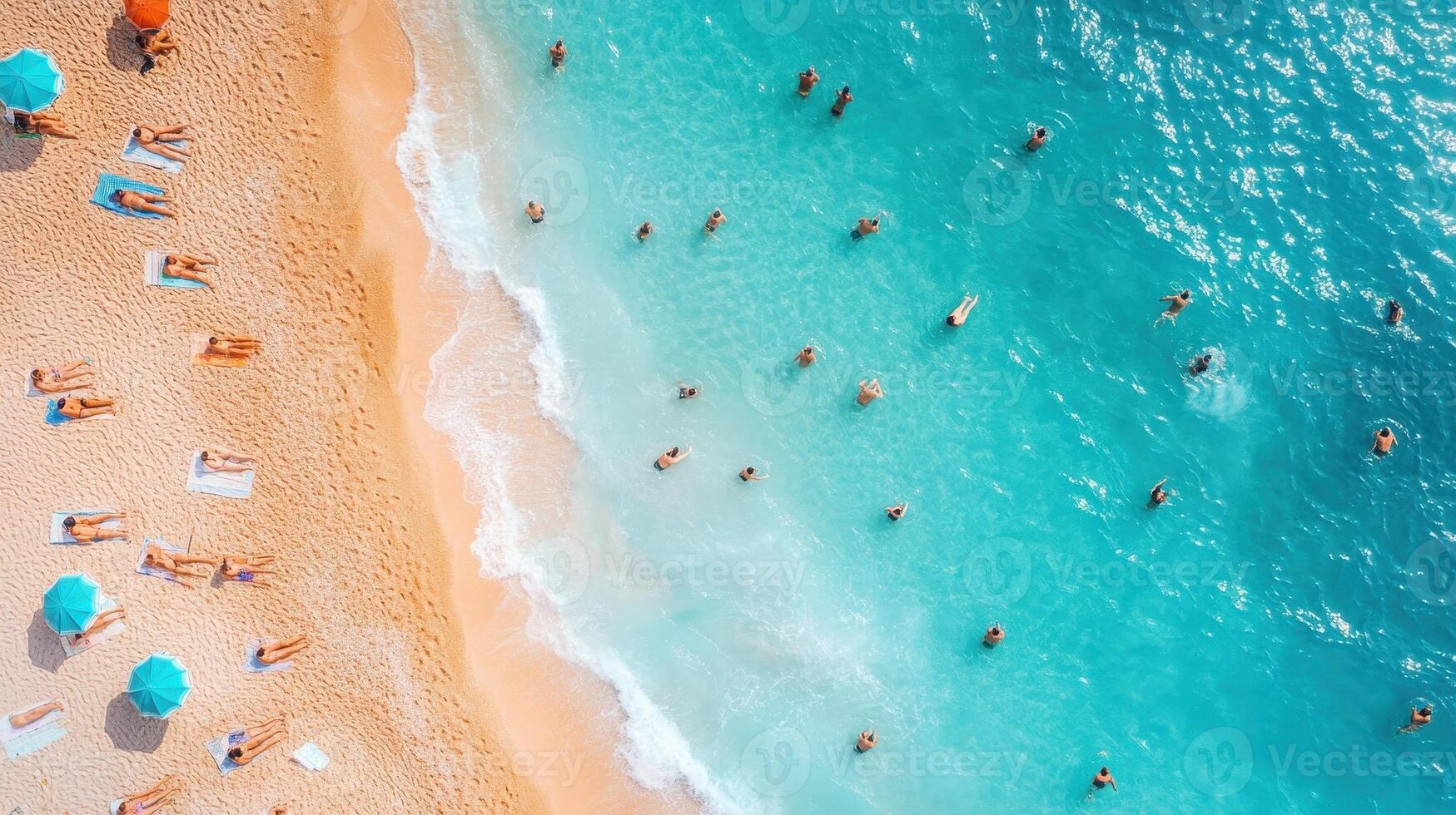 Aerial view of crowded beach, turquoise water, sunbathers, swimmers photo