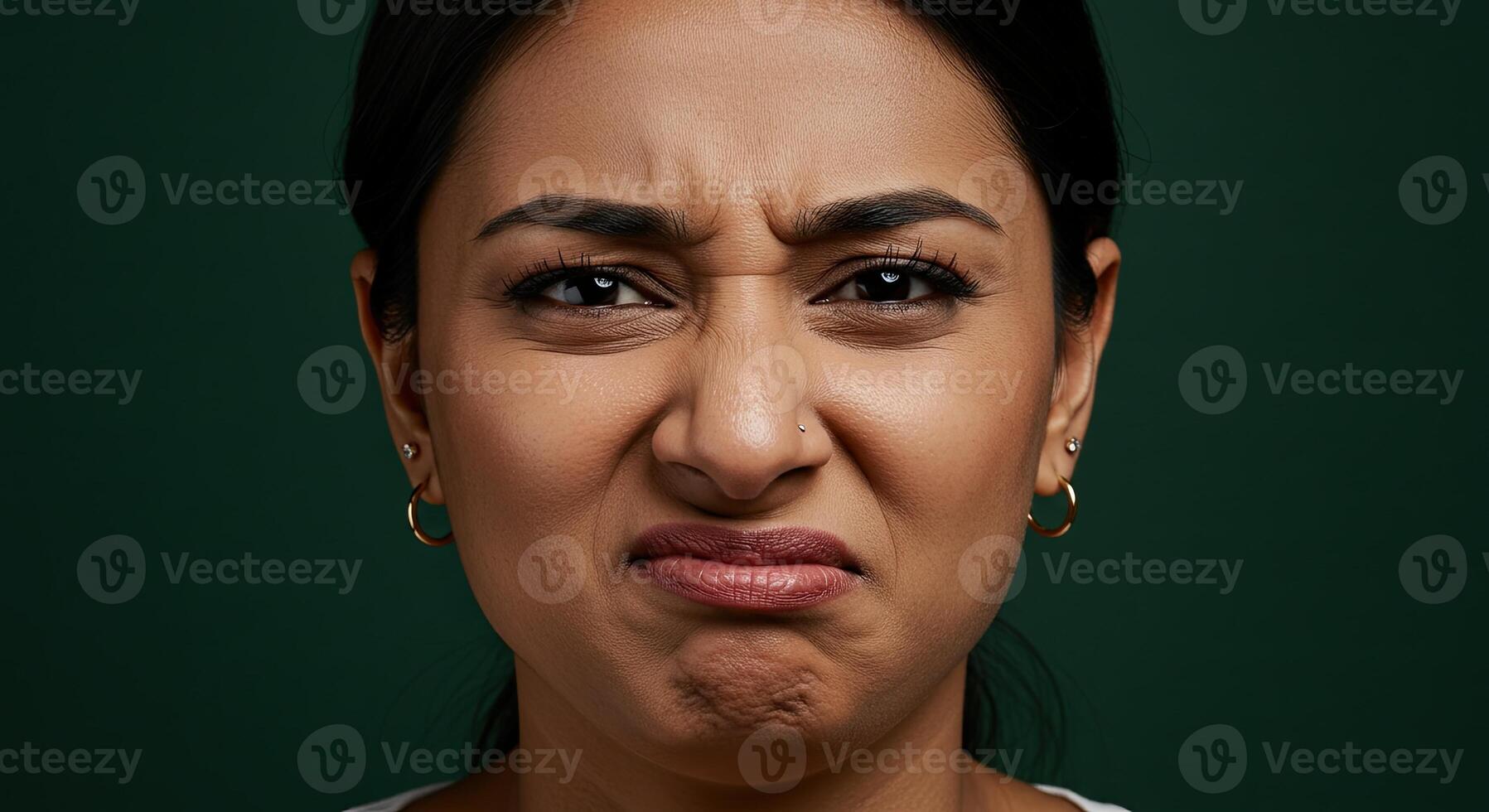 Disgusted woman with a scrunched face expressing strong negative emotion photo