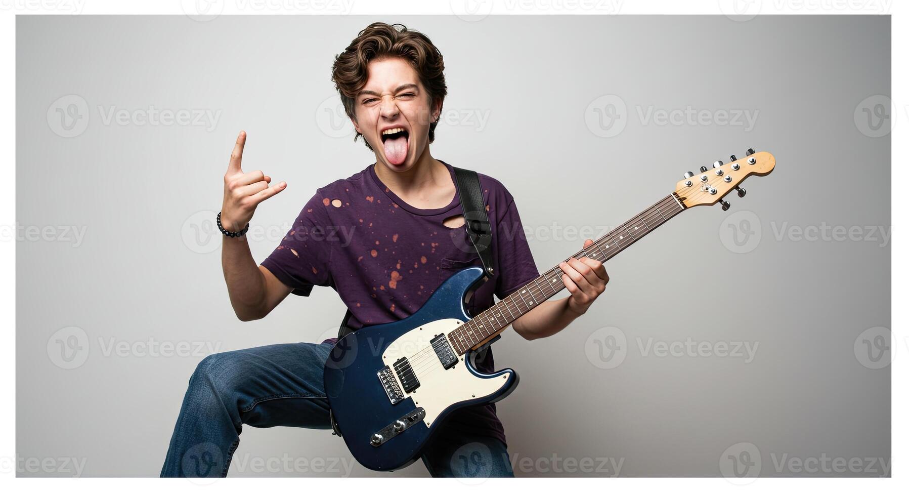 Energetic young man playing electric guitar making rock on hand gesture photo