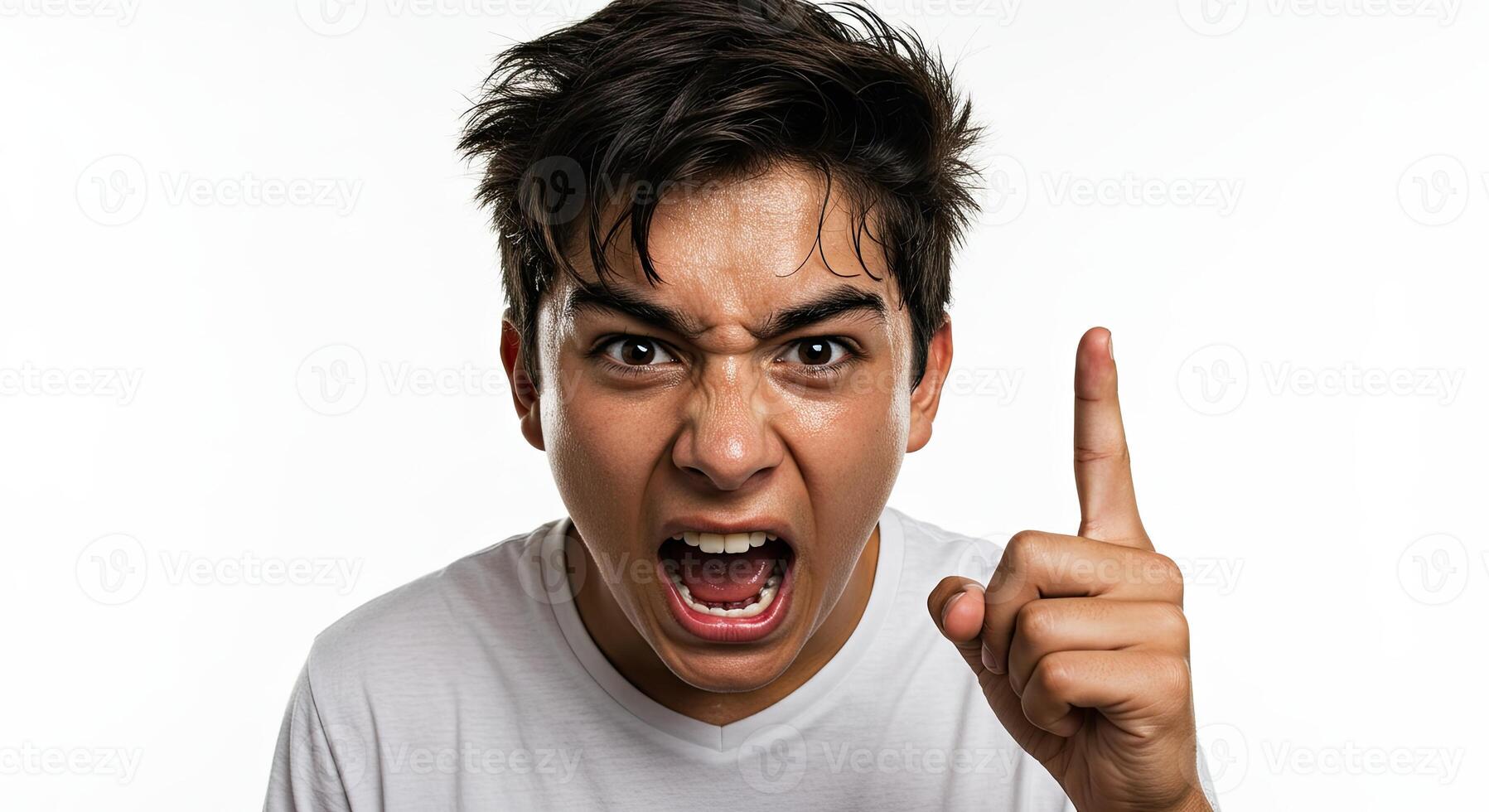 Furious young man shouting and gesturing with finger up against white photo