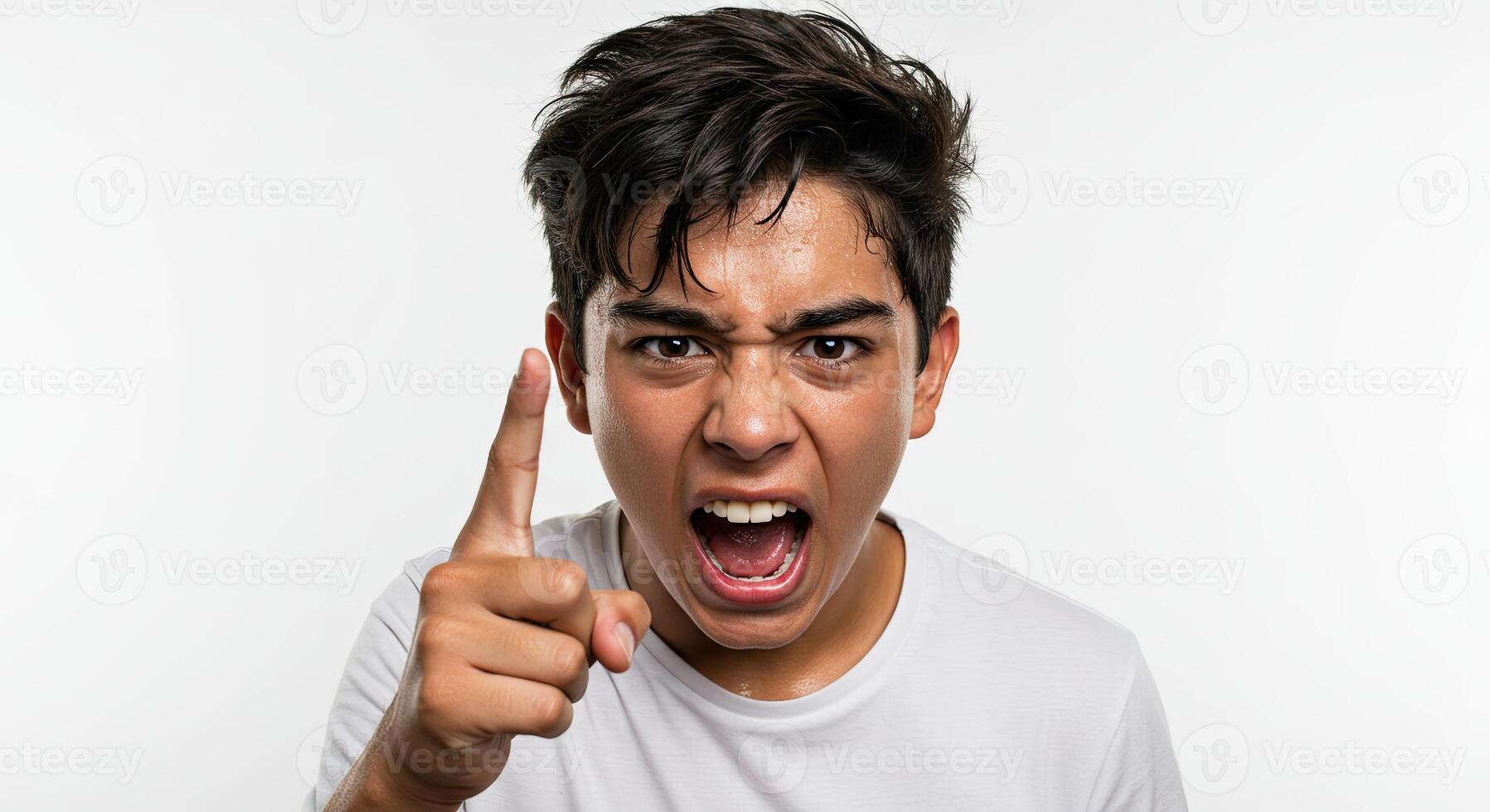 Furious young man yelling and pointing his finger with an angry expression photo