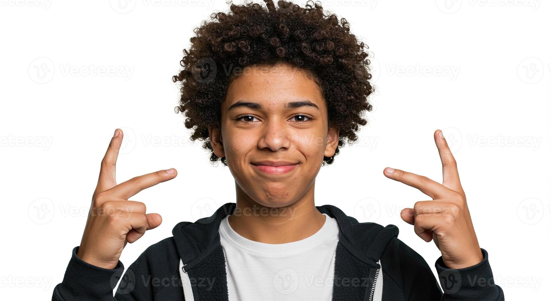 Smiling African American teen pointing fingers up on white background photo