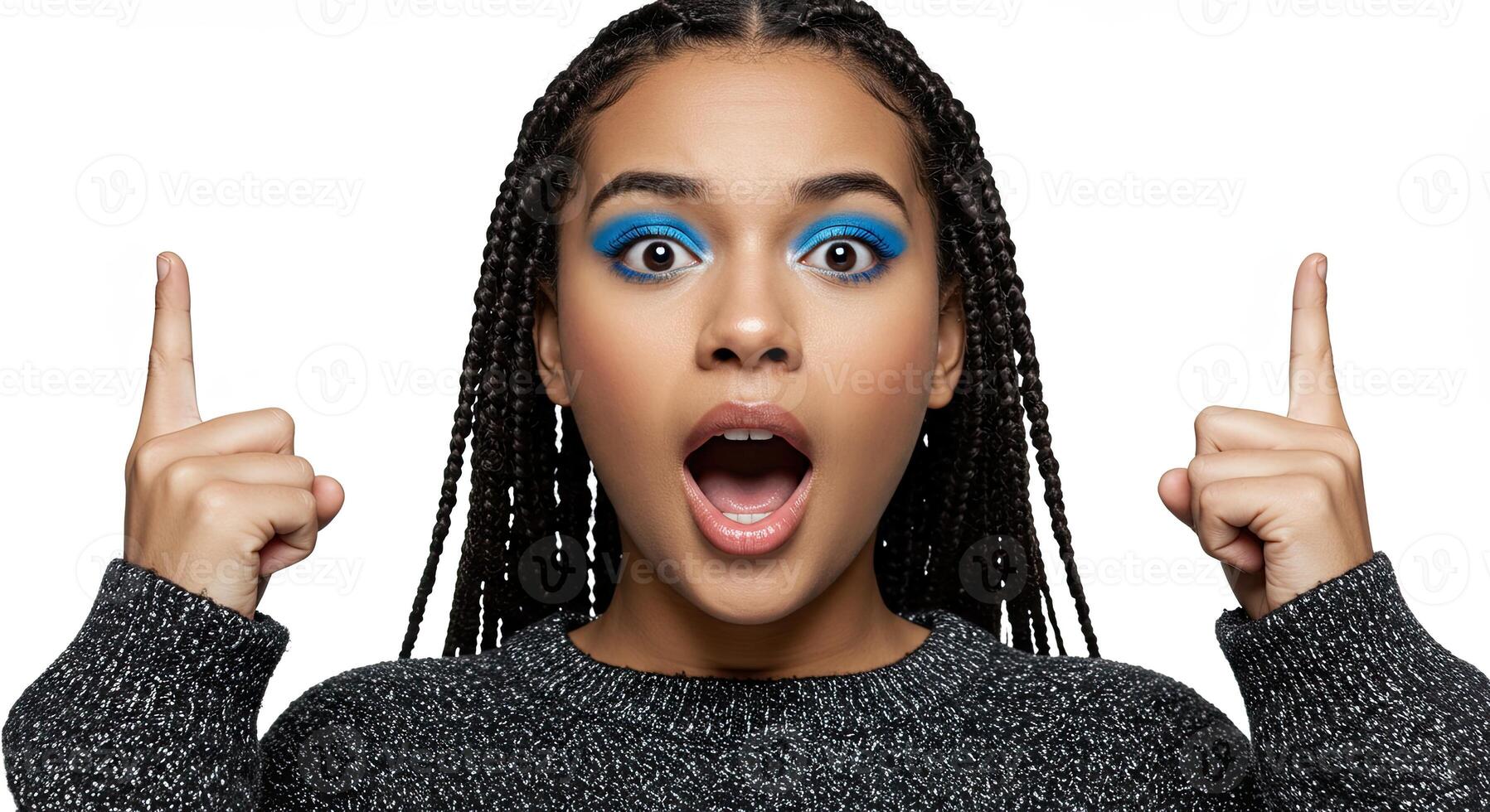 Surprised young woman with vibrant blue eyeshadow pointing upwards photo