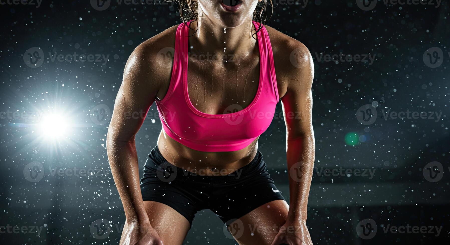 Sweaty Female Athlete Resting After Intense Workout With Dramatic Lighting photo