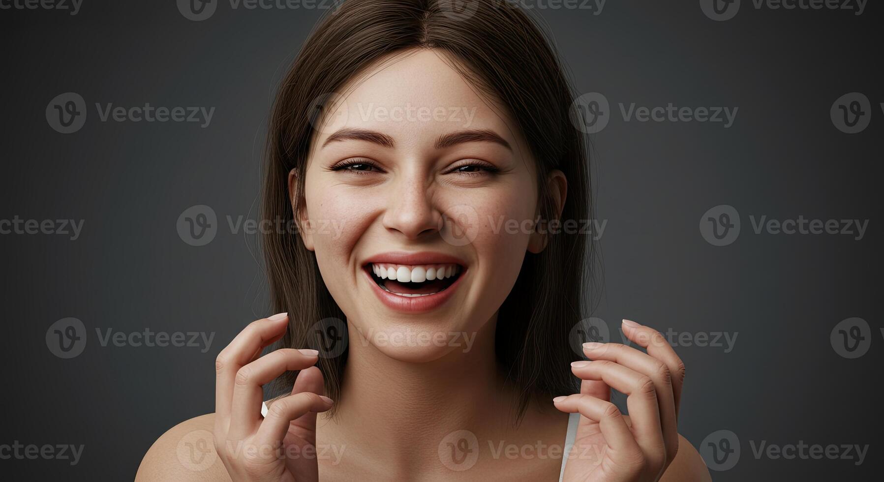 Young adult woman laughing joyfully with hands raised and expressive face photo