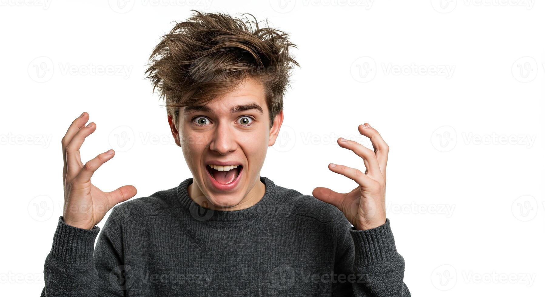 Young man with messy hair expressing shock and excitement raising hands photo