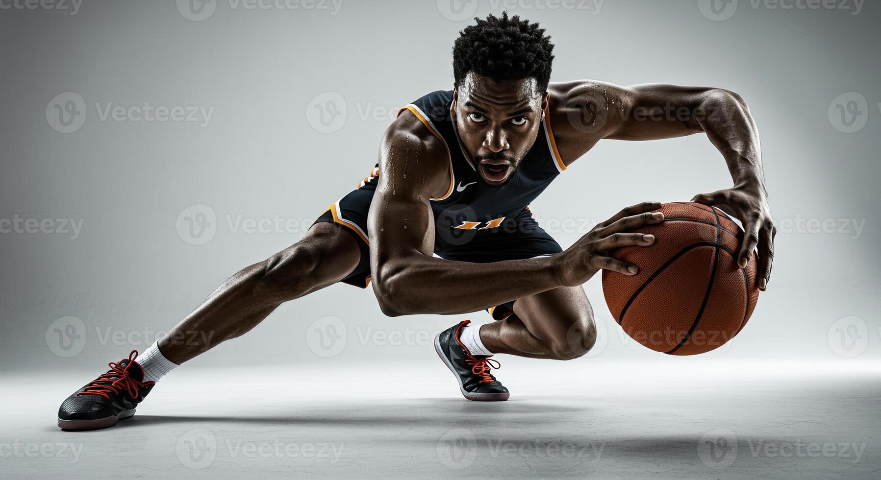 Intense african american basketball player dribbling the ball with focus photo