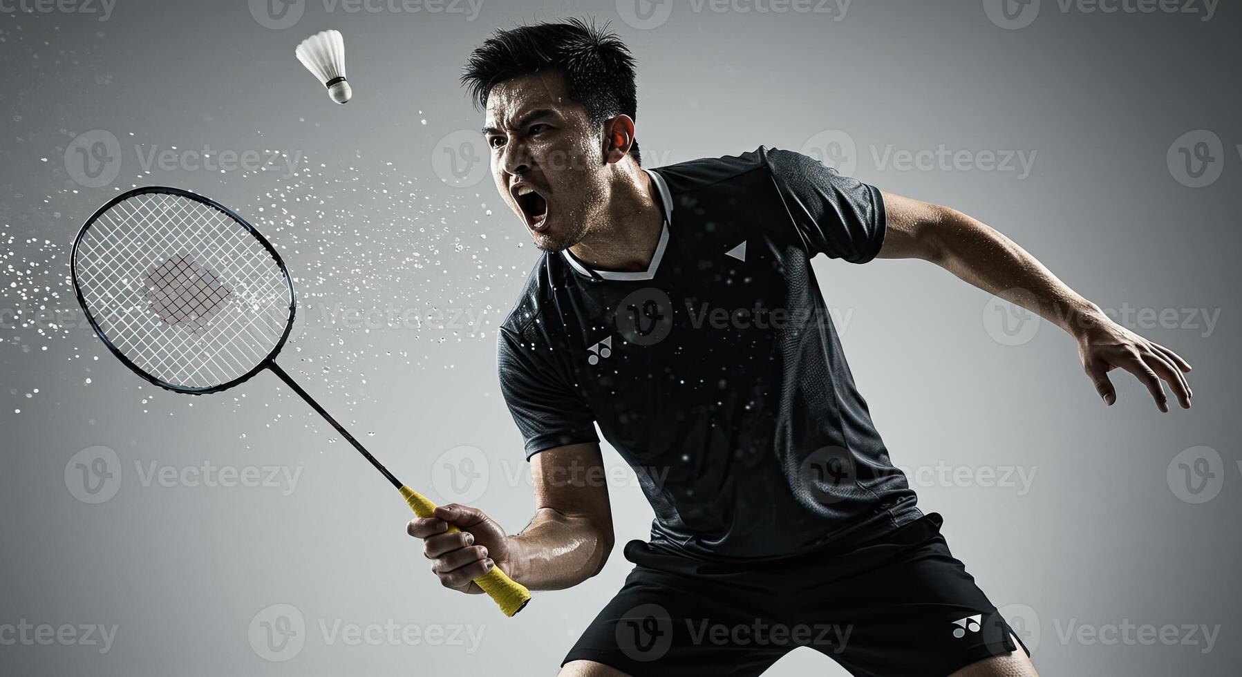Intense badminton player smashing shuttlecock in action shot studio image photo