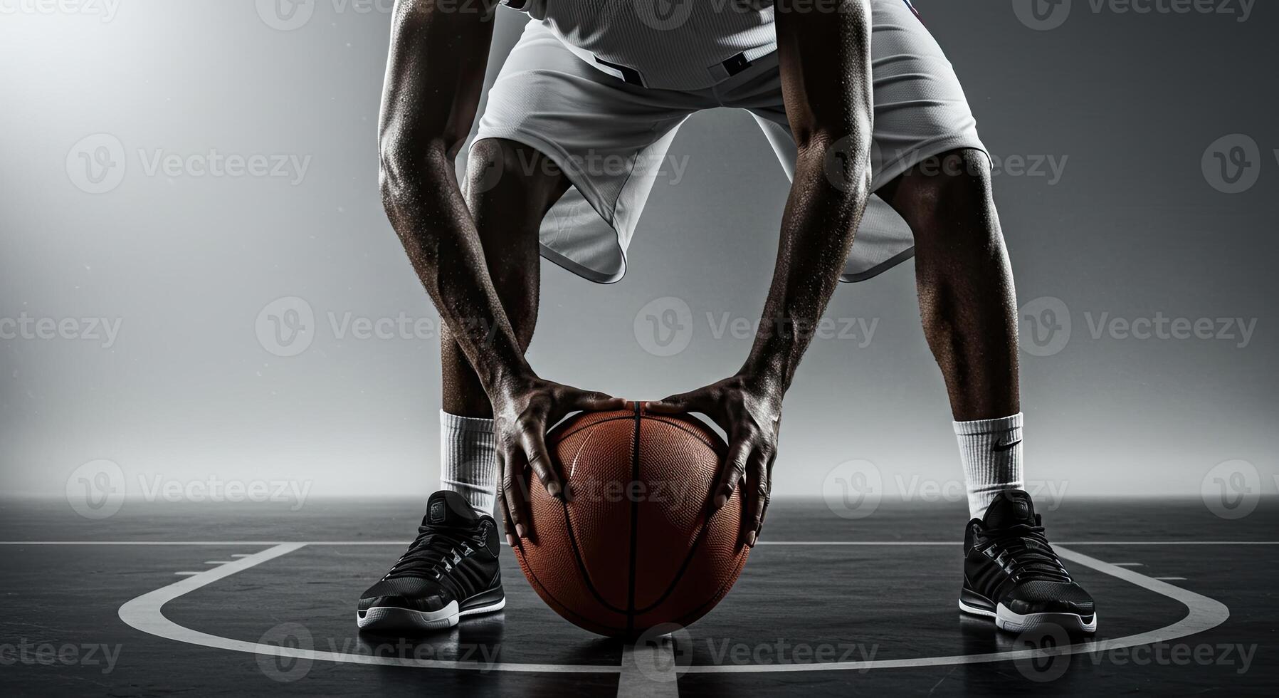 Intense basketball player holding ball on court ready for action shot photo