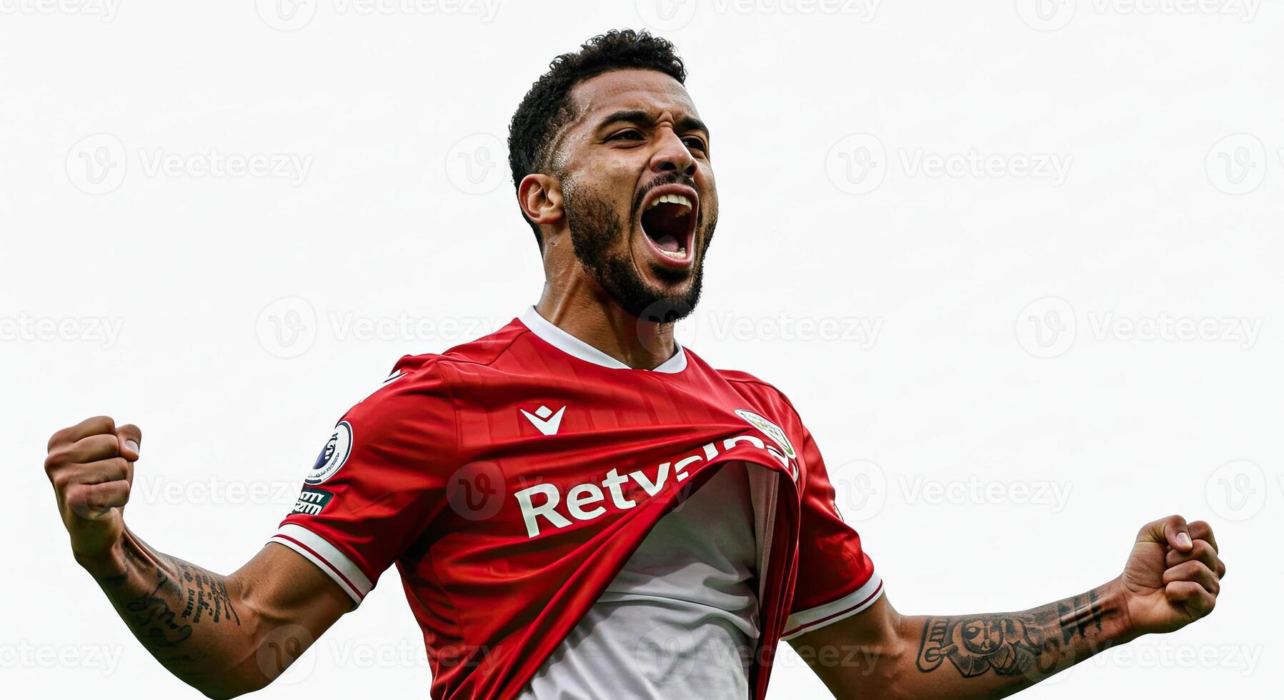 Soccer player celebrates victory with open mouth and arms raised in jubilation photo