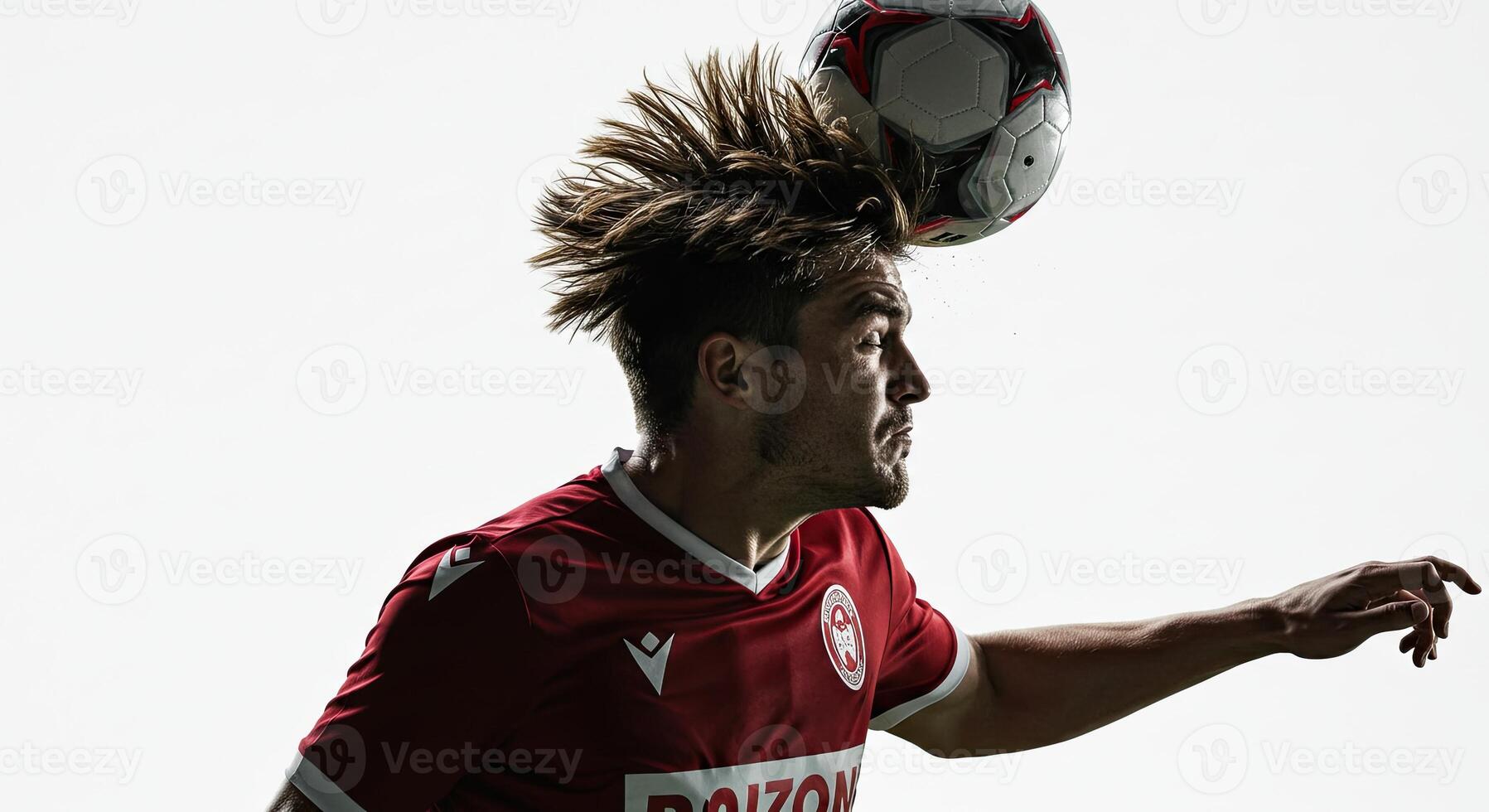 Soccer player heading a ball with determination against a bright white background. photo