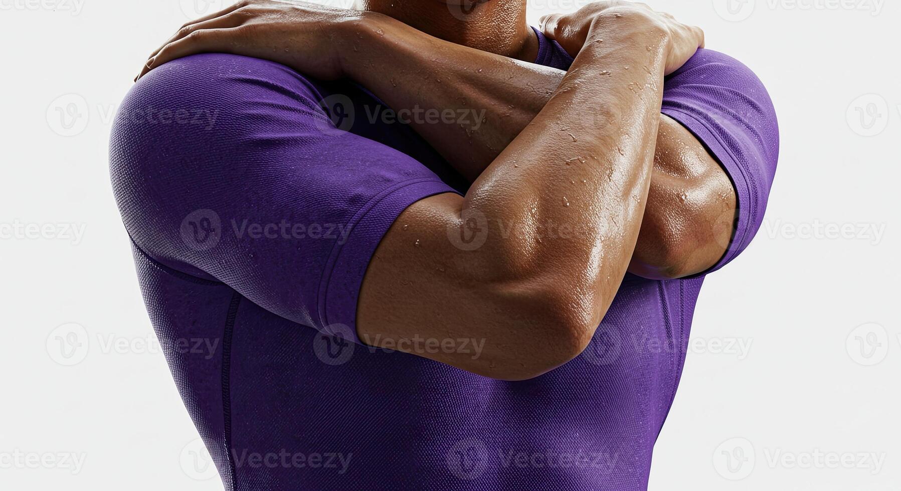 Sweaty athlete hugs himself after intense workout wearing purple shirt photo