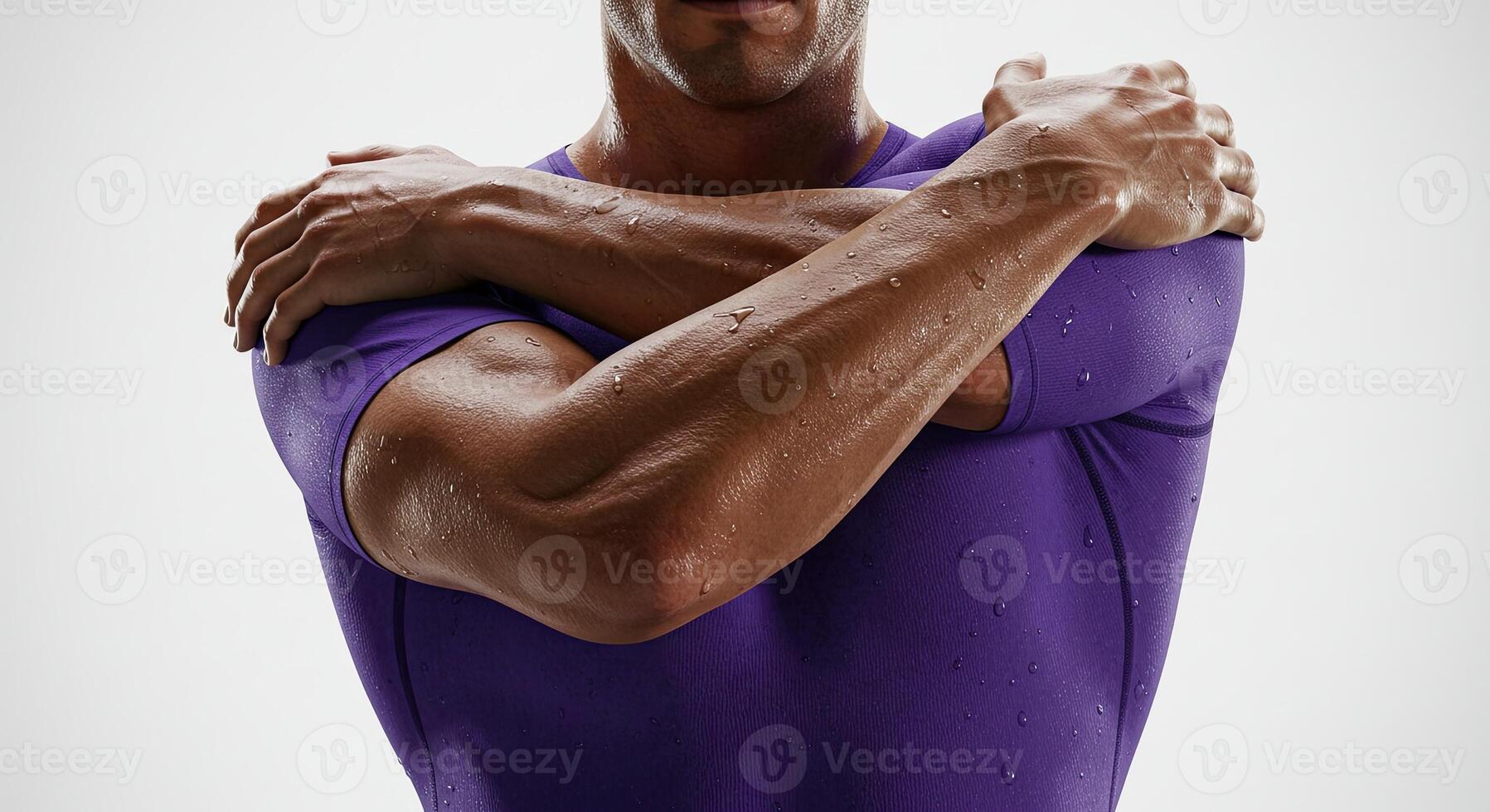 Sweaty athletic man crosses arms after intense workout or fitness training photo