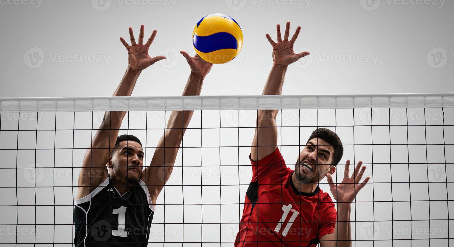 Two male athletes jumping to block a volleyball during a competitive match photo