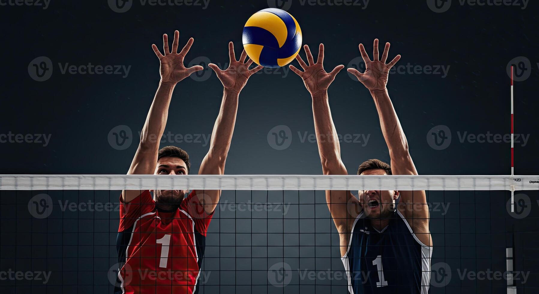 Two male volleyball players jumping and blocking the ball at the net in action photo