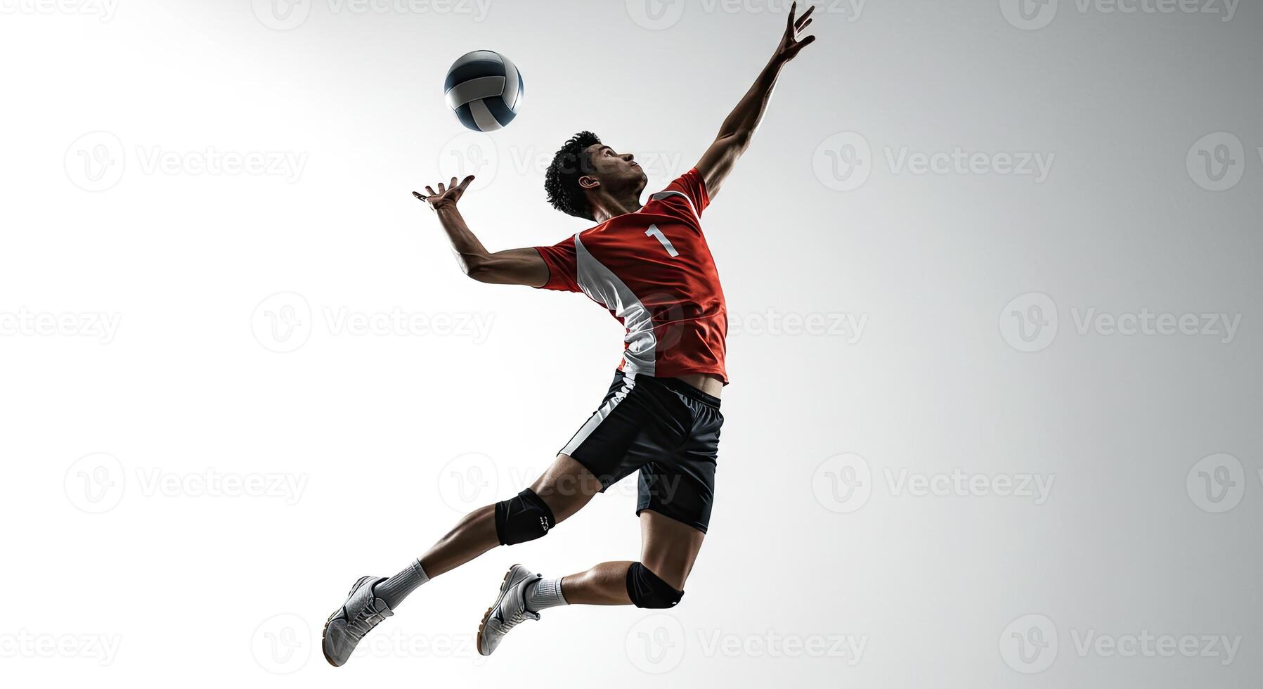 Young male athlete jumping and spiking a volleyball against a white background photo