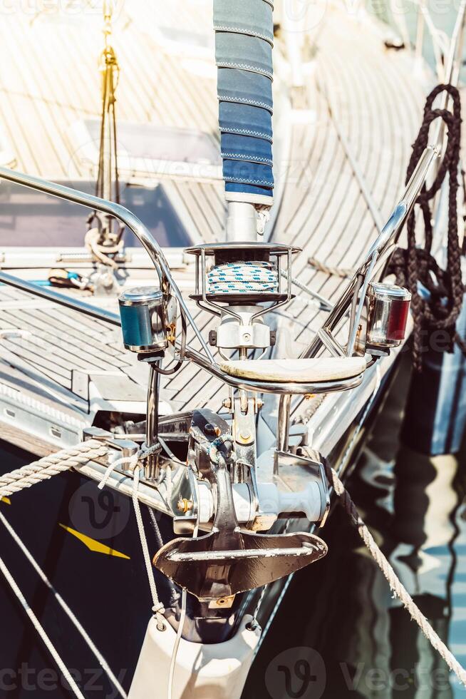 Sailboat deck close-up with ropes and metal fixtures, nautical concept background photo