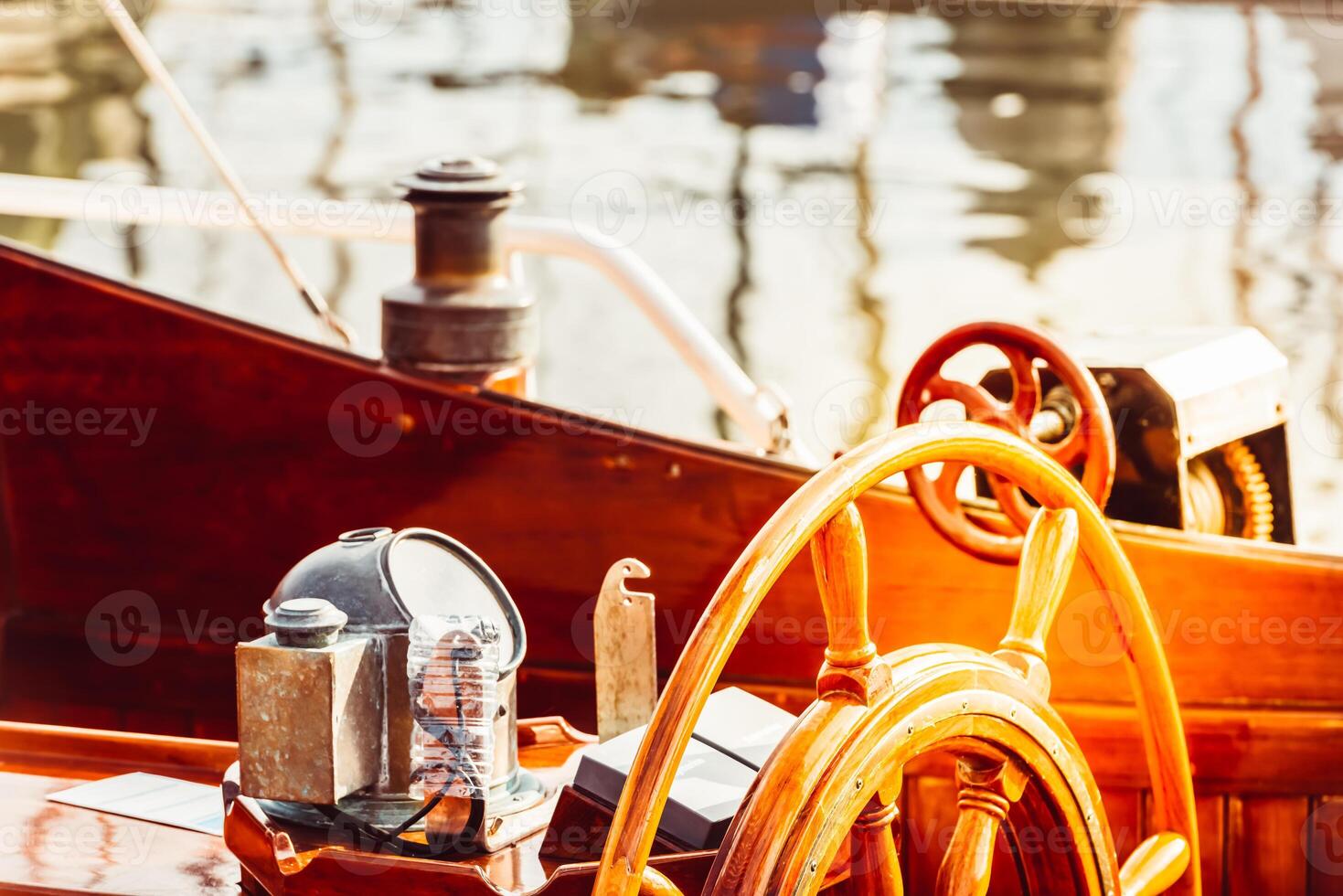 Wooden boat steering wheel and ship details creating nautical atmosphere photo