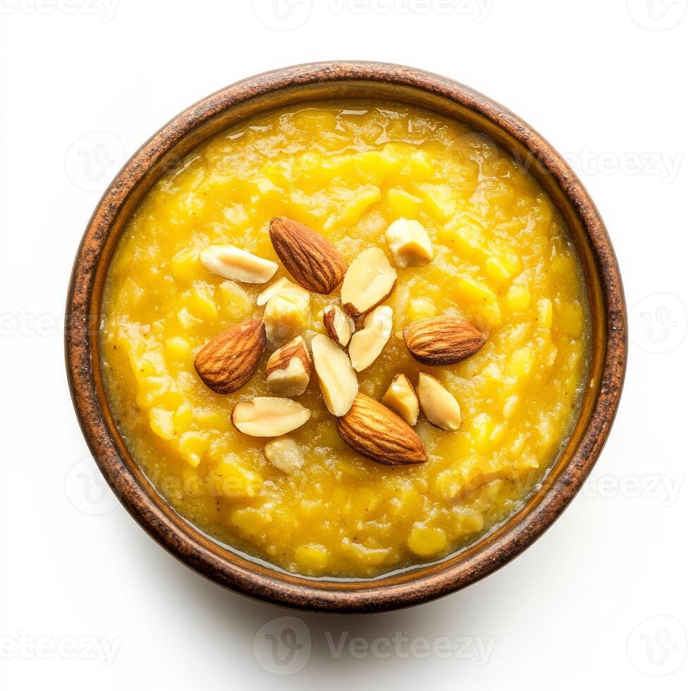 A bowl of moong dal halwa, with a sweet pudding made from mung beans, milk, and sugar, garnished with nuts and cardamom, isolated photo