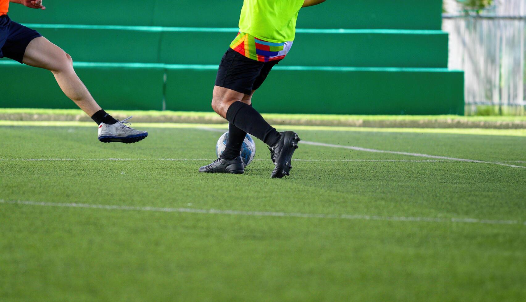 Two men playing soccer on a field photo