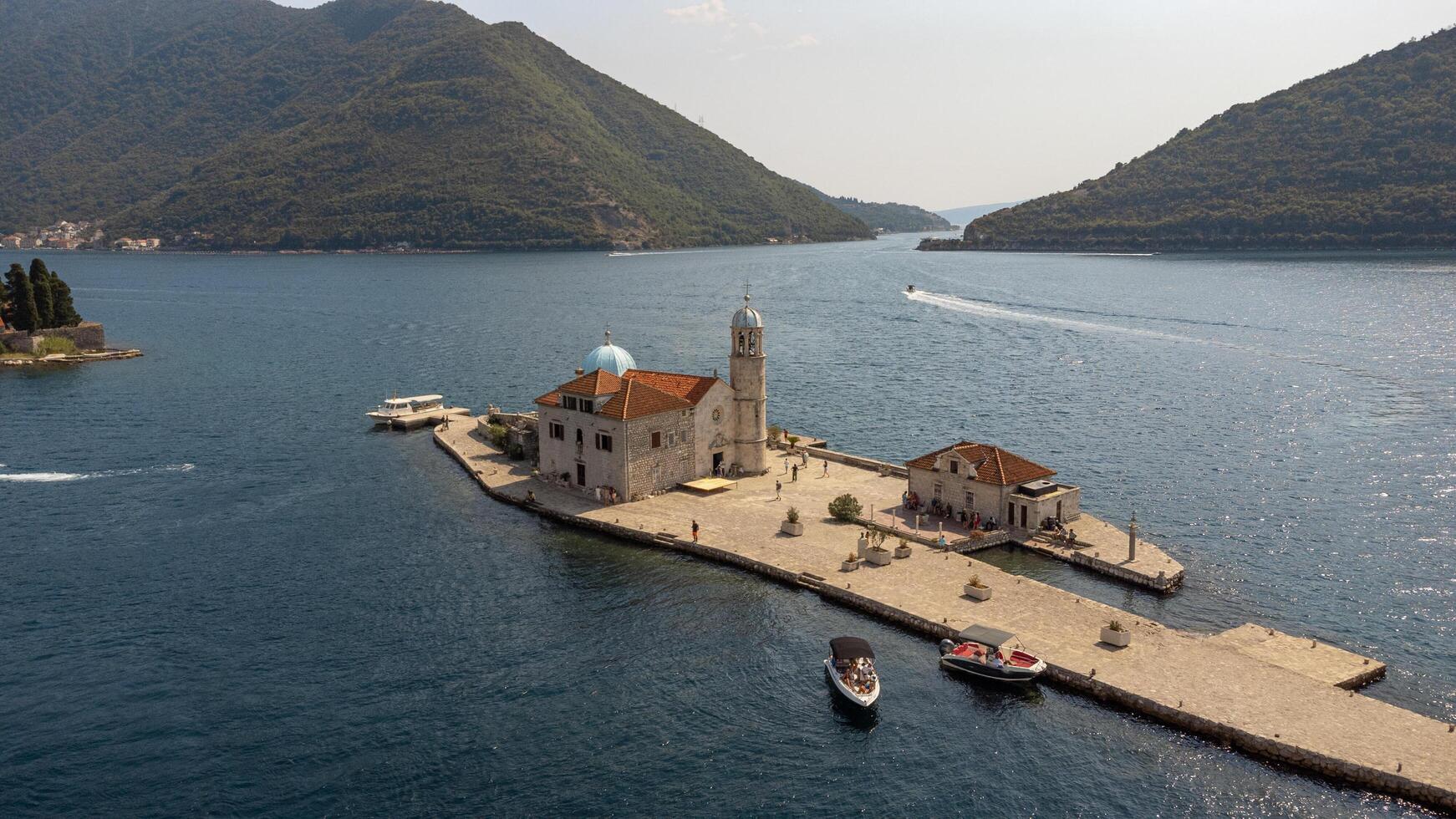 Bay of Kotor, Montenegro, 08-27-2024, Aerial view of islands with the church of our lady of the rocks centered in the image. Tourist attraction in summer near Perast in the Bay of Kotor, Montenegro photo