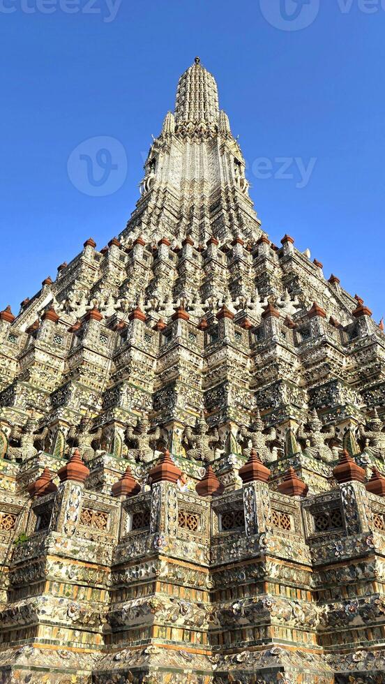 Majestic Wat Arun Temple Against Clear Blue Sky photo