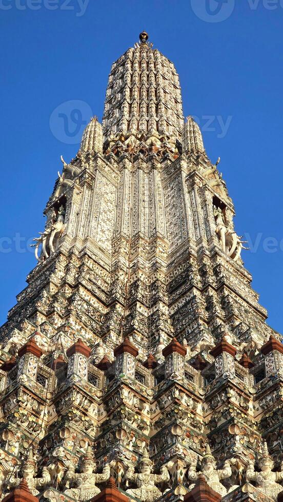 Wat Arun Temple Spire Under Blue Sky photo