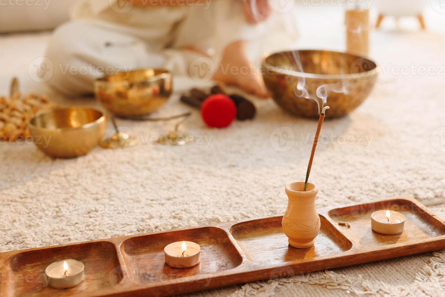 Incense and candles burning in peaceful sound therapy meditation setup with Tibetan singing bowls. photo