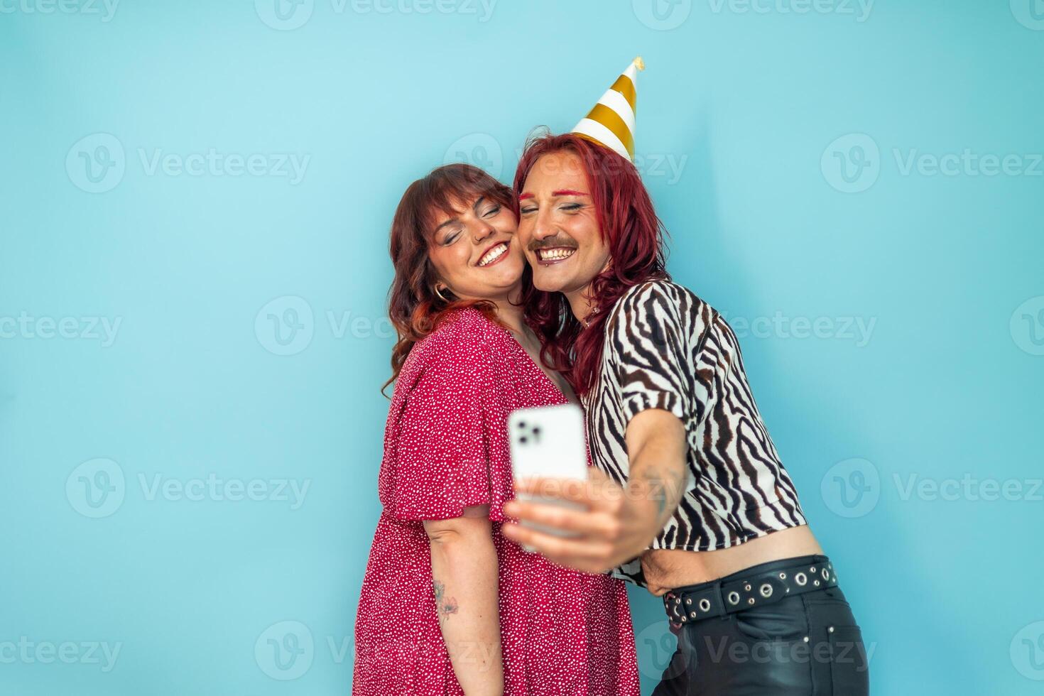 Non-binary person and curvy woman taking a selfie at a birthday party photo