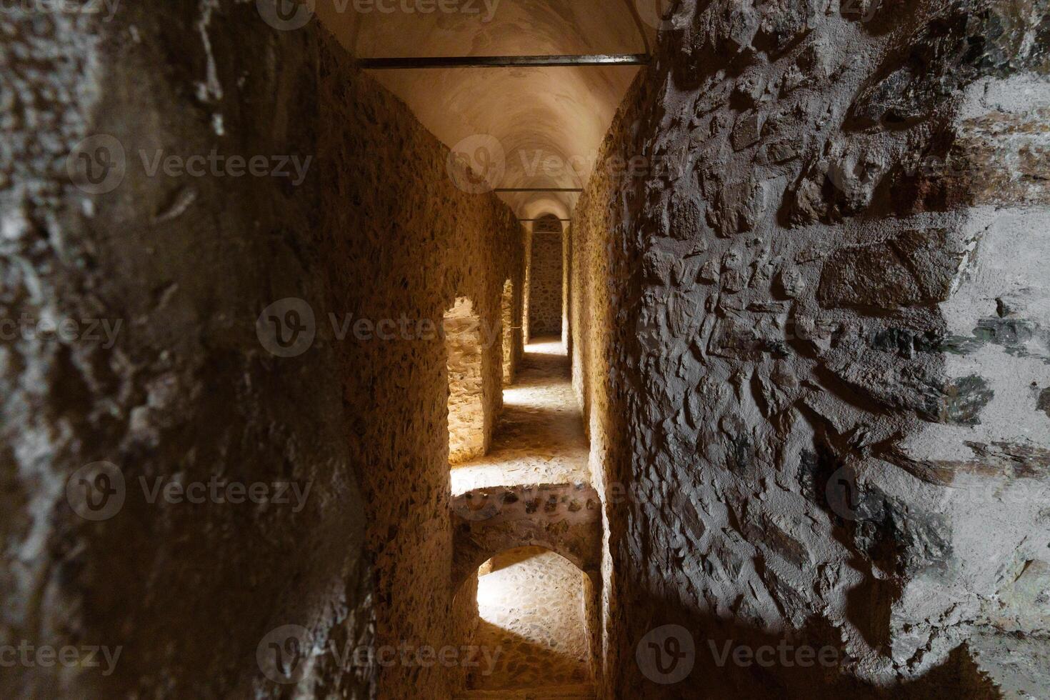 Historic castle Stone Corridor with Atmospheric Lighting photo