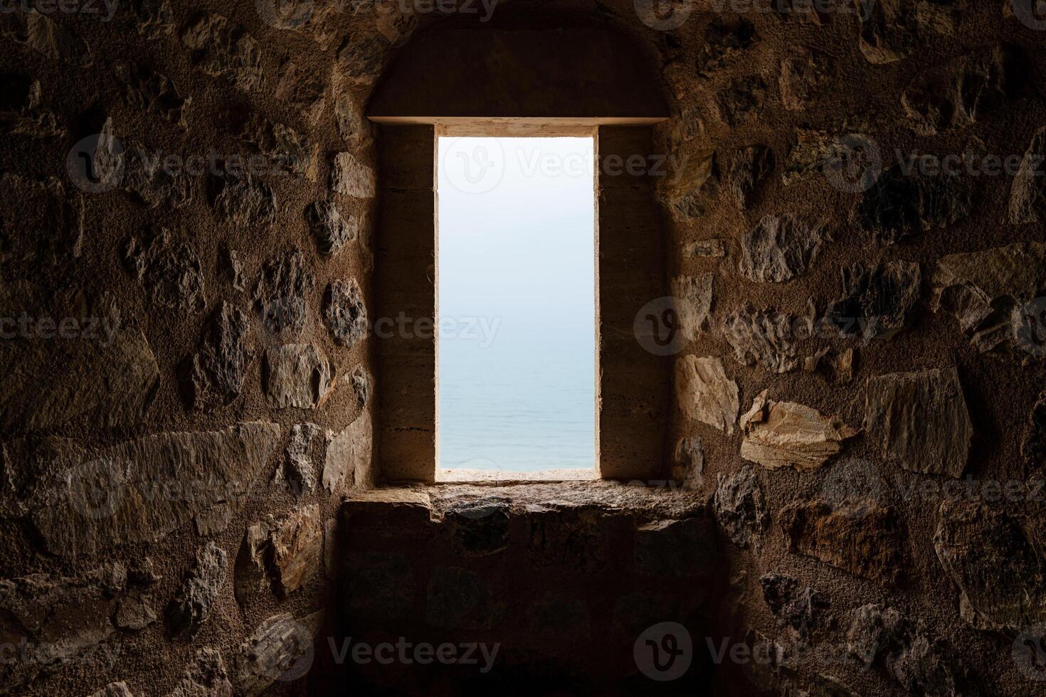 Mystical Stone Corridor Illuminated by Light Through an Open window photo