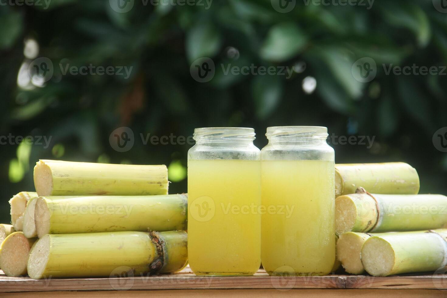 A drink made from squeezed yellow sugar cane juice or Saccharum officinarum L which is part of the Poaceae family, a drink made from squeezed sugar cane juice which is neatly arranged photo