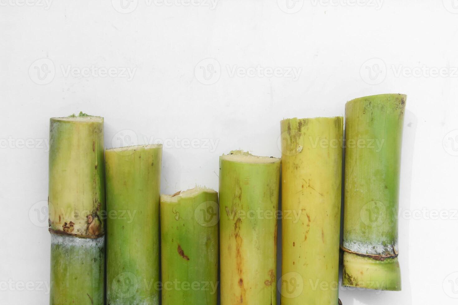 Yellow sugar cane stalks or Saccharum officinarum arranged and isolated on a white background photo