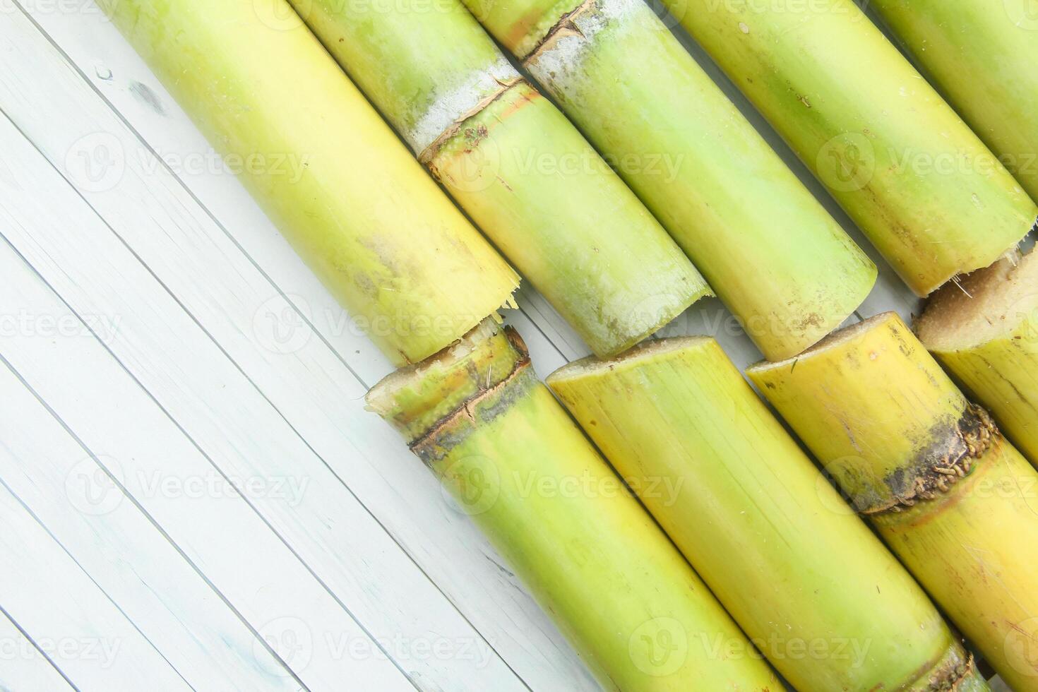 Several green bamboo sticks on a white wooden table photo