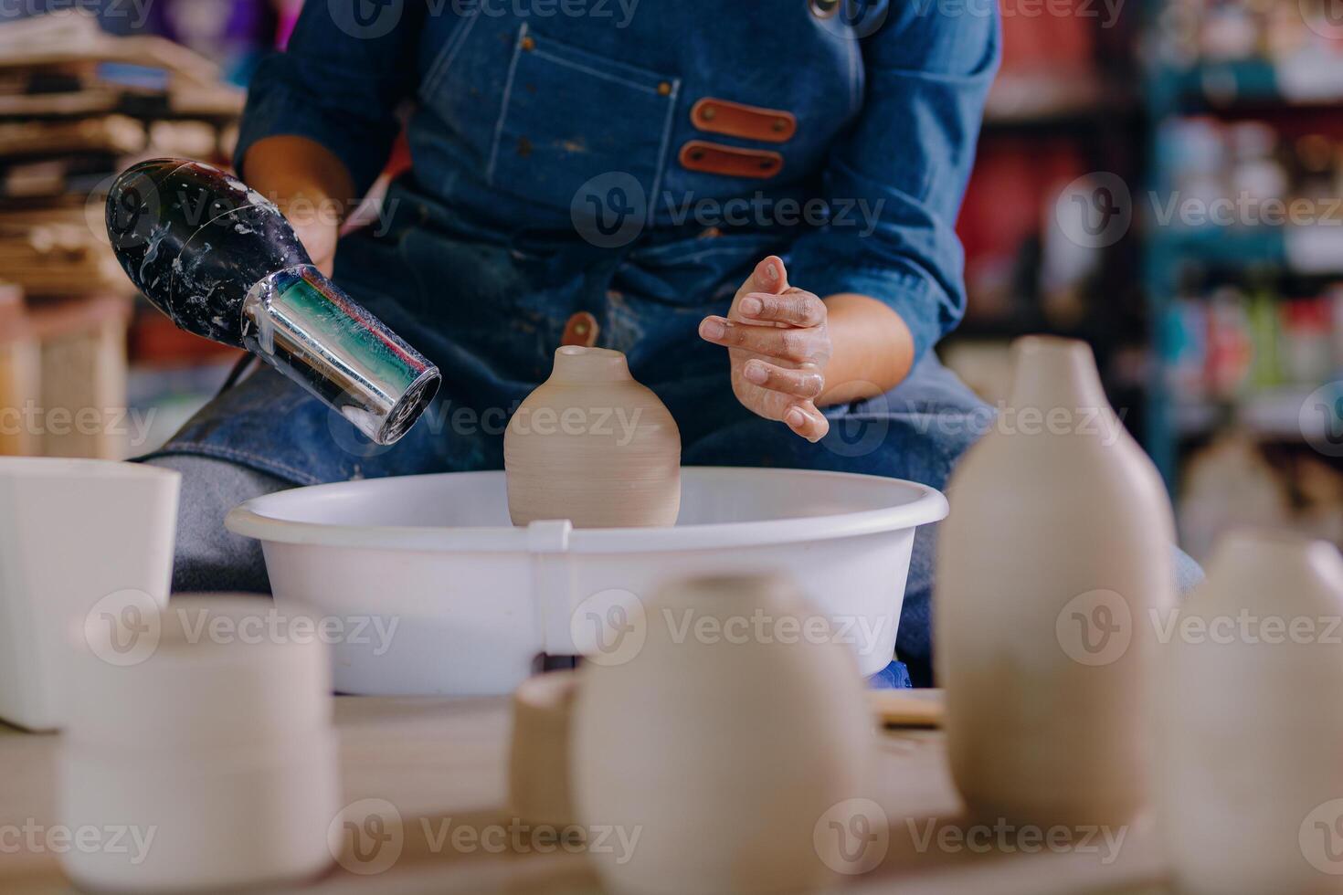 A woman is making a vase photo